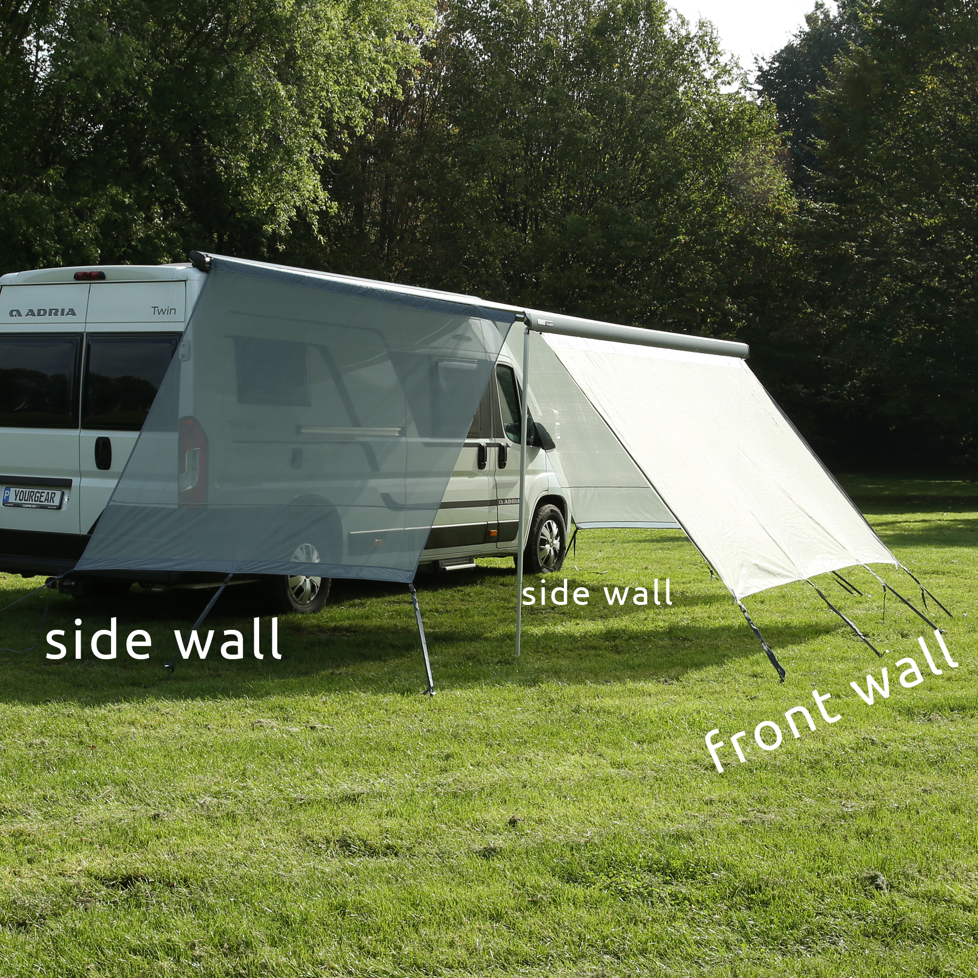 your GEAR Capri Side Blocker Set: two wind-permeable mesh side walls mounted on a campervan awning, providing sun and privacy protection, suitable for 250 cm extension, shown outdoors on a grassy field.