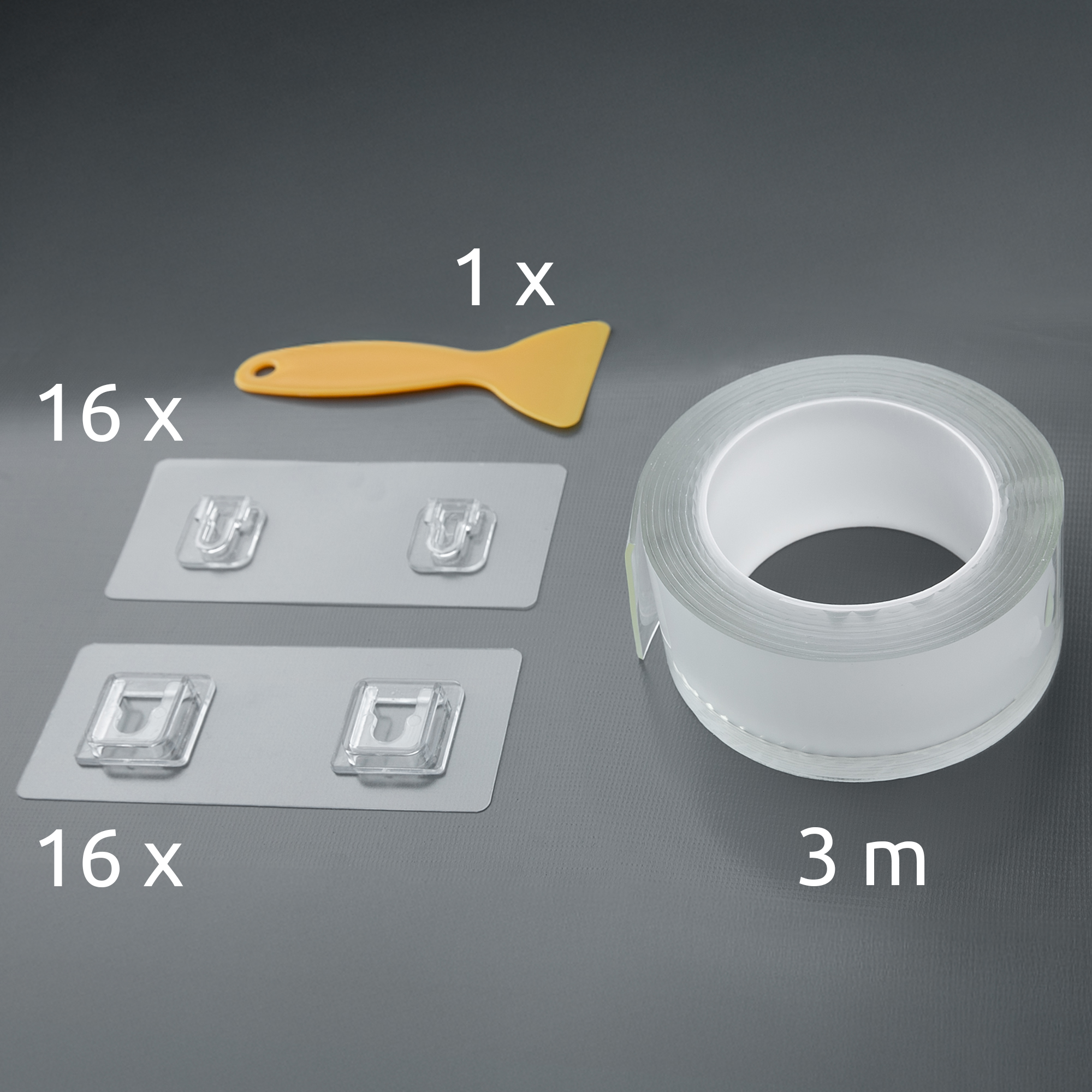 Set with 16 adhesive hooks, 1 yellow scraper, and a 3-meter roll of transparent mounting tape, suitable for organizing and mounting items in camper vans or RVs. All parts are arranged on a gray background.