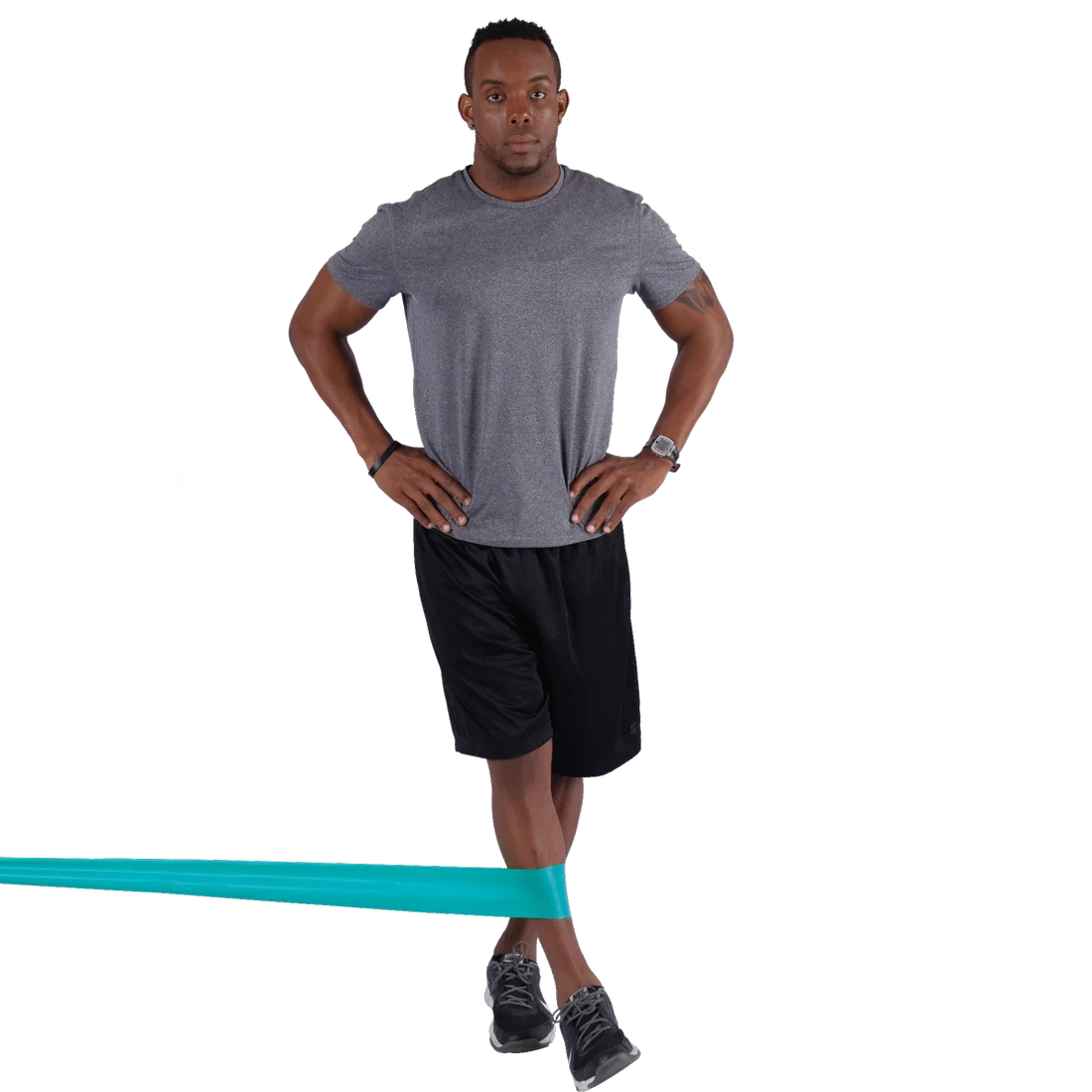 Man using Spirit Fitnessband 13.5 kg, latex-free exercise band (183x10 cm) for resistance training. The turquoise band is looped around his legs, demonstrating lower body workout.