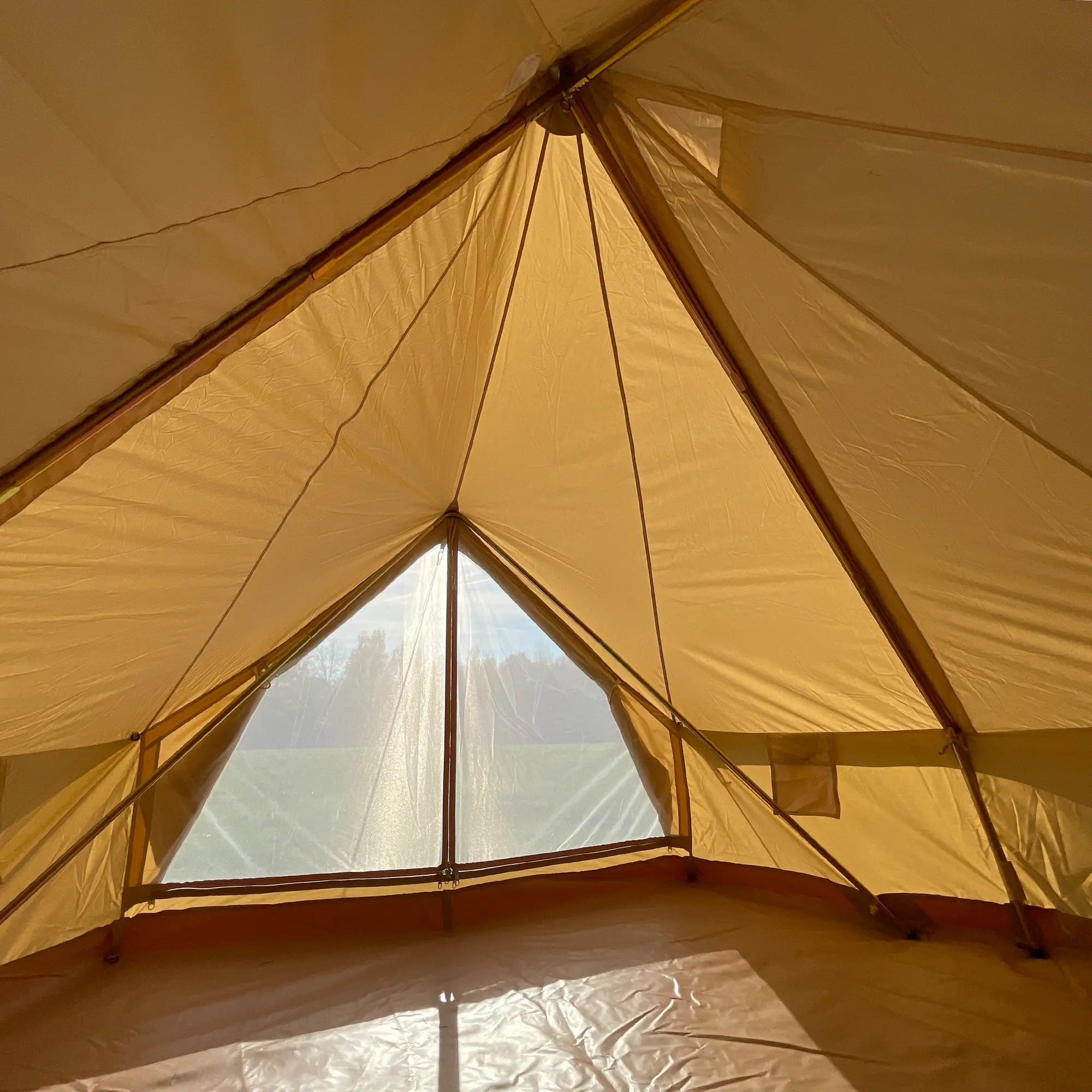 Interior view of your GEAR Gobi 3 cotton tipi tent, showing the spacious floor area, A-frame entrance, mesh window with cover, and innovative pole structure without a center pole.