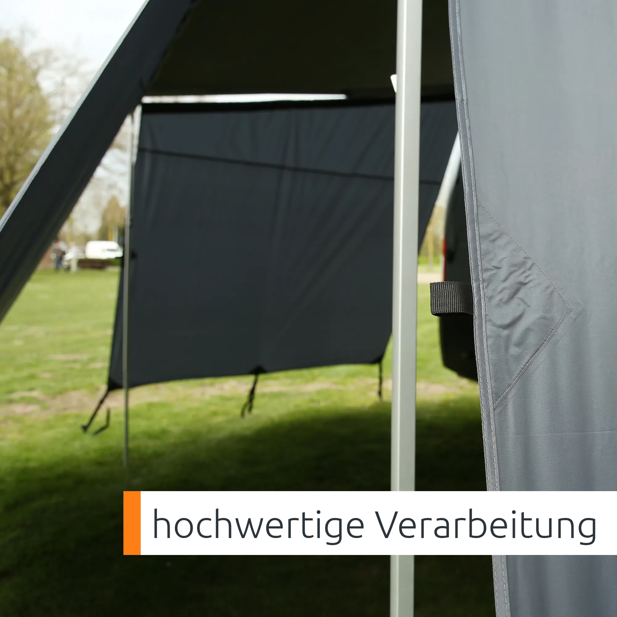 Grey your GEAR Korsika 2.4 awning wall set mounted on caravan awning showing front panel and two side panels, weatherproof fabric, reinforced seams, attachment strap and aluminum support pole in grassy campsite