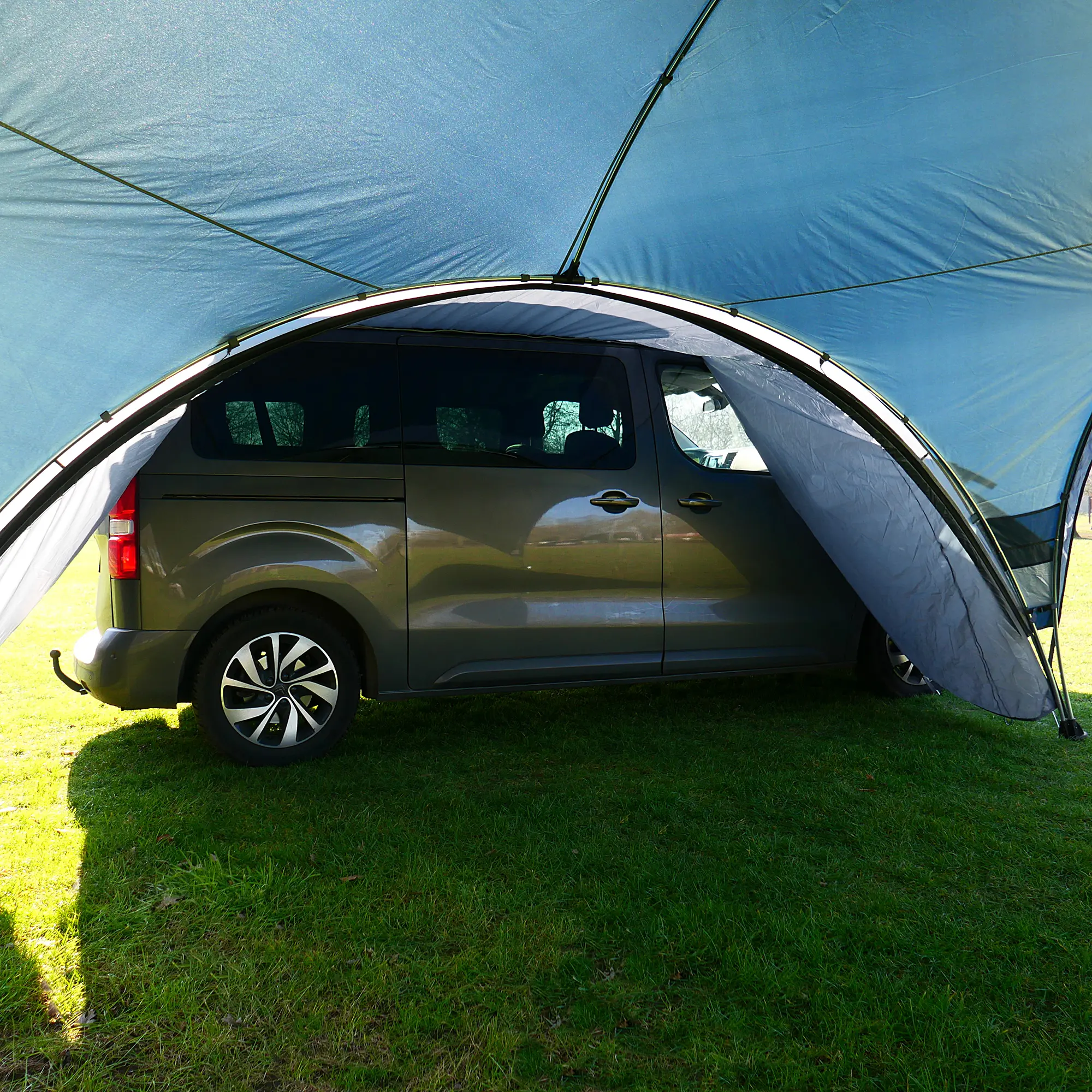 Van connected to your GEAR Bergamo 430 Bus Connector, creating a weather-protected passage between the vehicle and event pavilion; features durable zippers and fits various vehicle roofs. Outdoor camping setup.