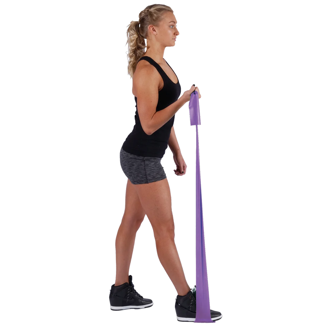 Woman exercising with Spirit Fitnessband 18 kg, purple latex-free resistance band, 183x10 cm, wearing sportswear, demonstrating strength training for arms and legs. Ideal for gym, rehabilitation, and home workouts.