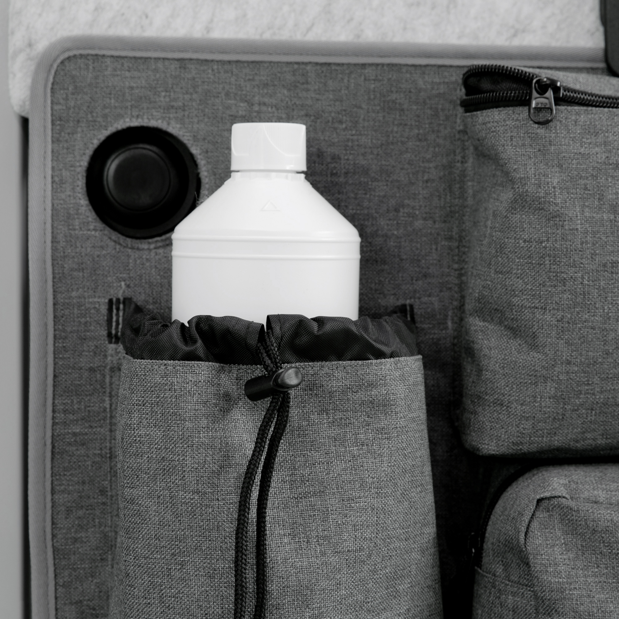 your GEAR Ortles R organizer for camper van right rear door, shown with multiple grey fabric pockets, including a large pocket holding a white bottle, and zippered compartments for efficient storage.