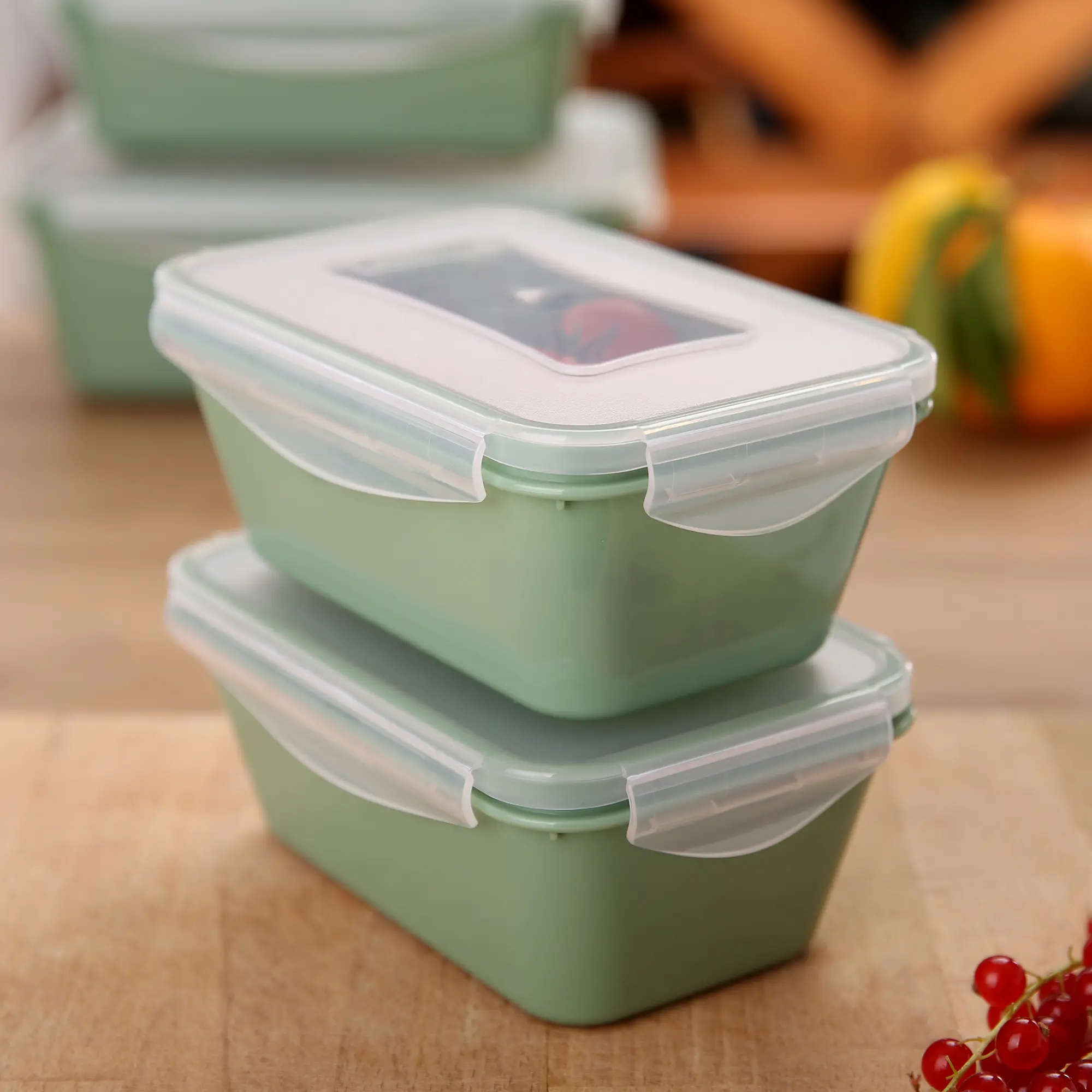 Two stackable your GEAR Pila food storage containers, each 700 ml, in light green with transparent lids and secure clips, shown on a kitchen surface. Ideal for fridge, freezer, microwave, and dishwasher use.