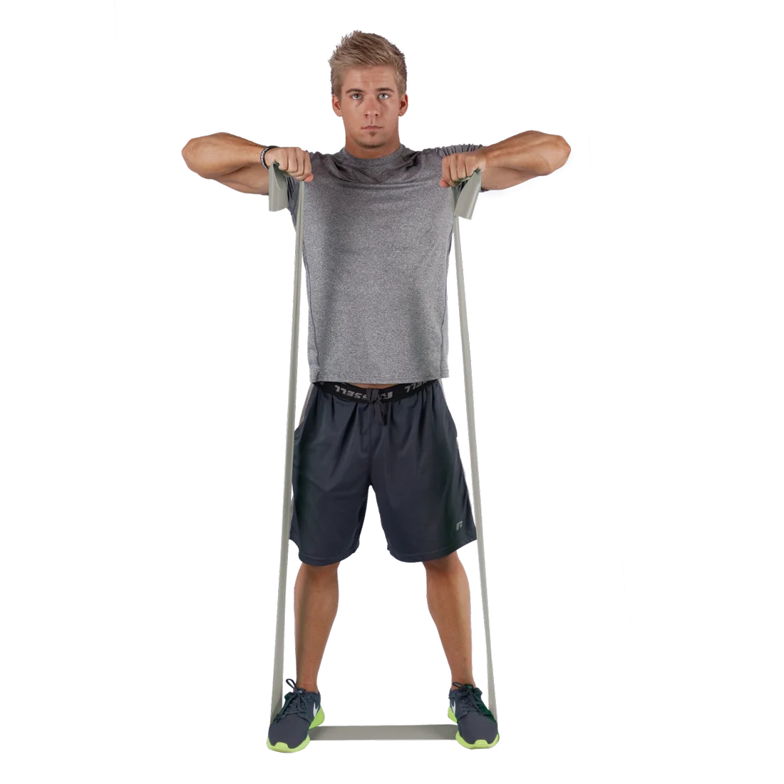 Man exercising with Spirit Fitnessband, 183x10 cm, 22.5 kg resistance, latex-free expander. The grey resistance band is stretched from feet to hands, suitable for strength and rehabilitation training.