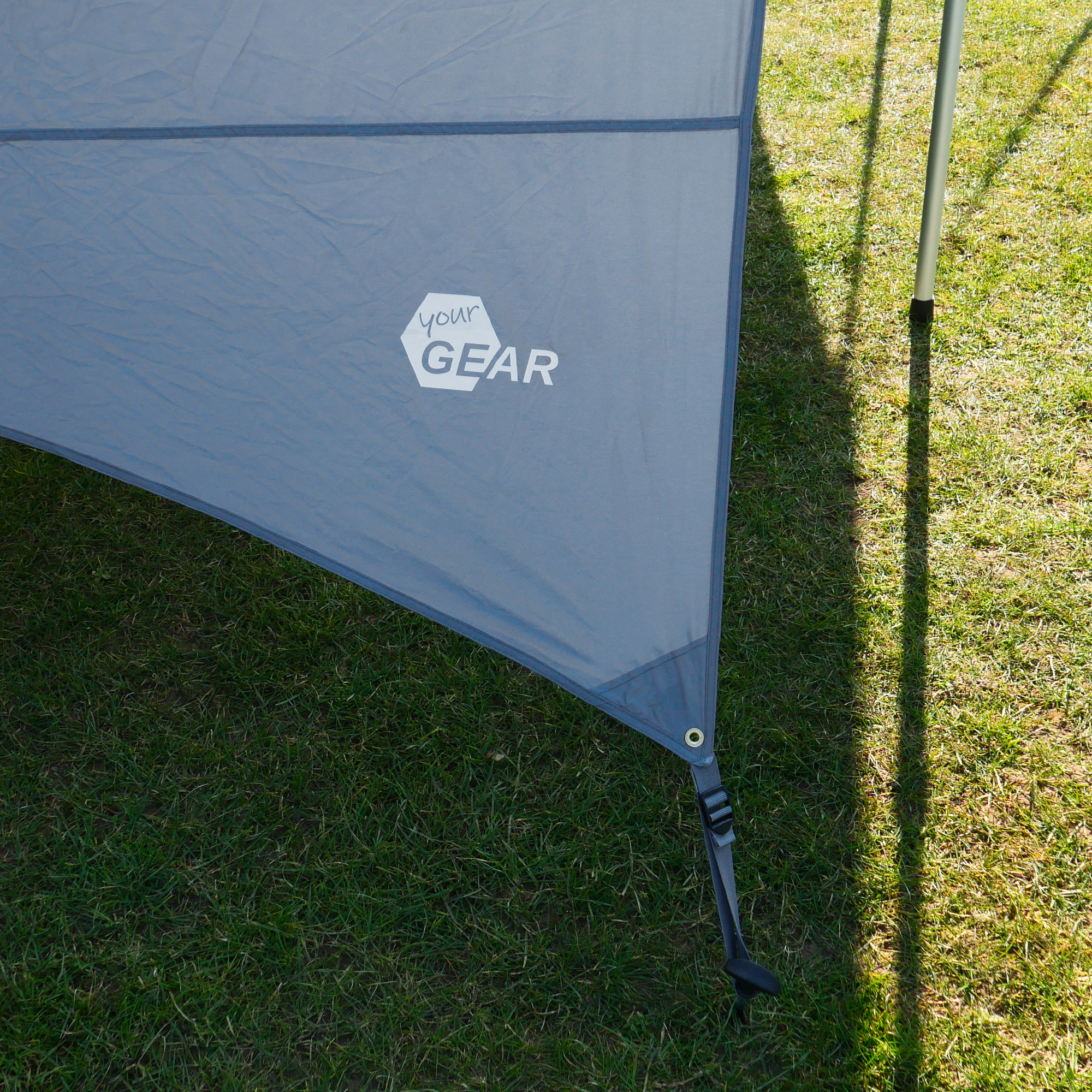 Gray your GEAR Tropea bus awning with UV 50+ protection, shown with side wall, aluminum telescopic pole, and logo. Ideal as a sun and rain shelter for vans, motorhomes, or campers.