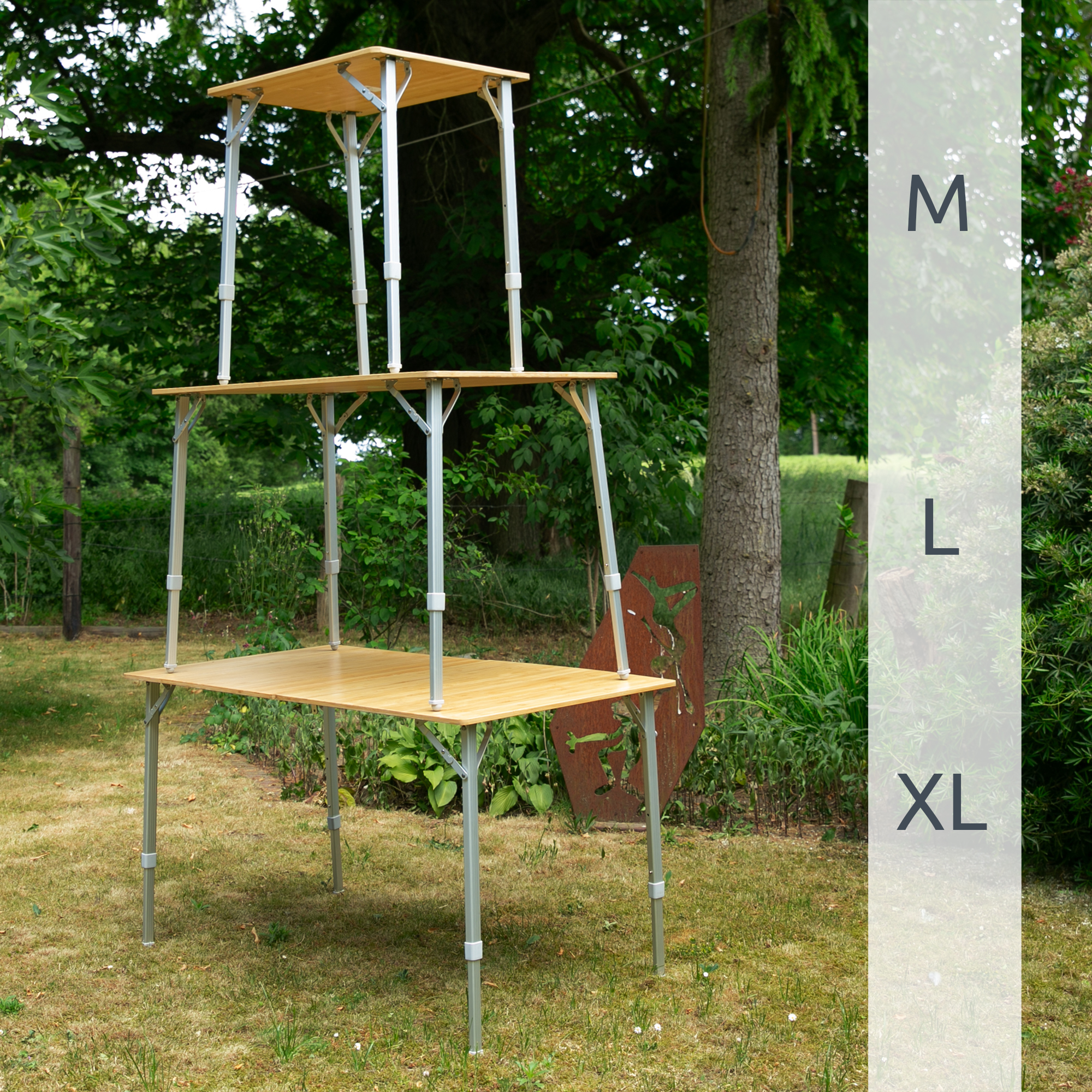 Bamboo camping table your GEAR Portofino L shown outdoors with three adjustable heights, sturdy aluminum telescopic legs, and natural bamboo tabletop, suitable for four people. Ideal for camping or garden use.