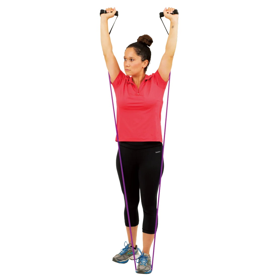 Woman using Spirit Expander Medium 13.5kg fitness resistance band for strength training, standing with both feet on the purple band and arms raised, holding handles; ideal for home workouts and gym exercises.