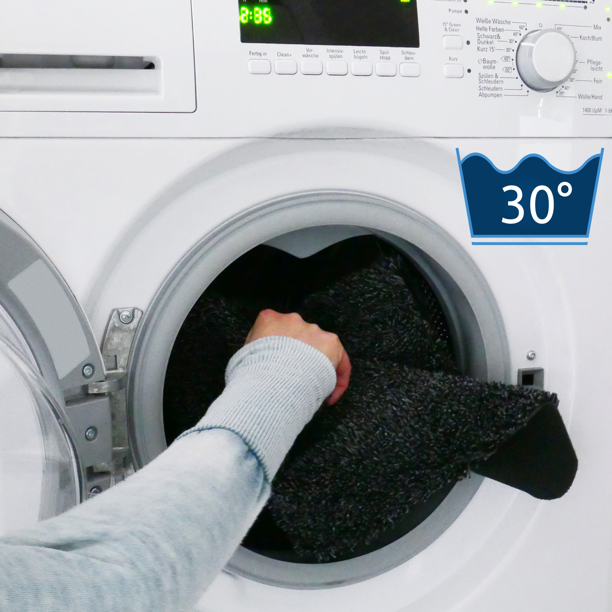 Tappeto your GEAR Magic Schmutzfangmatte 90x60cm nero in lavatrice, simbolo lavaggio 30°C, mostra la facilità di lavaggio e la praticità della stuoia assorbente e antiscivolo.