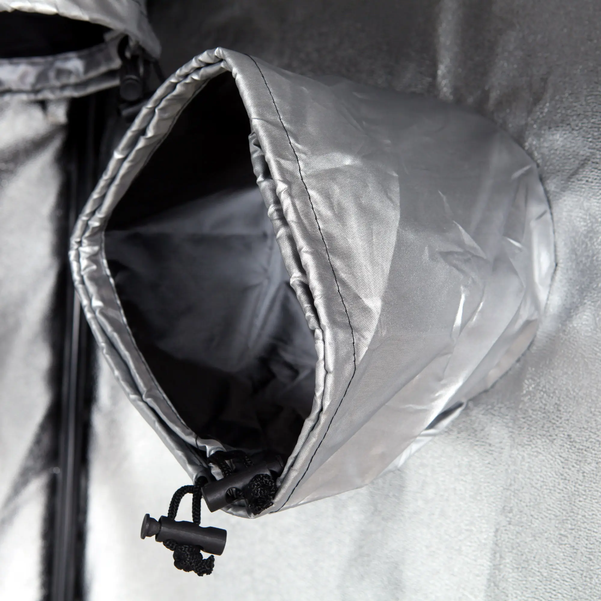 Close-up of a ventilation duct with adjustable drawstrings inside the yourGEAR Grow Tent Plantsville, showing reflective silver inner lining for optimal light efficiency in indoor plant cultivation.