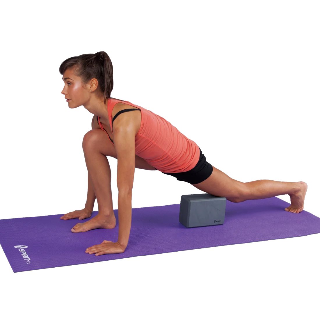 Woman doing a yoga stretch on a purple mat using a Spirit Yoga Block 23x15x10 cm, grey foam block, for support under her thigh. Ideal for yoga, Pilates, and fitness workouts.