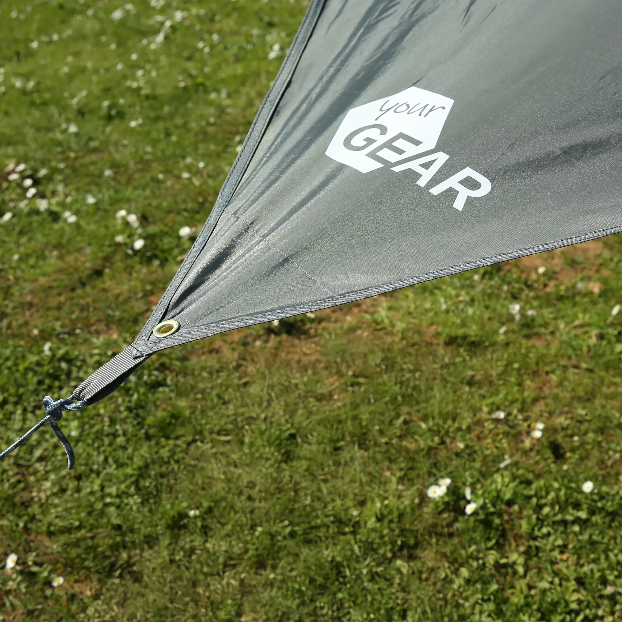 Gray your GEAR Atrani 3x3 m waterproof tarp corner with stitched hem, metal grommet, adjustable strap and rope, showing brand logo on UV-resistant grey fabric ideal for camping and sun protection.
