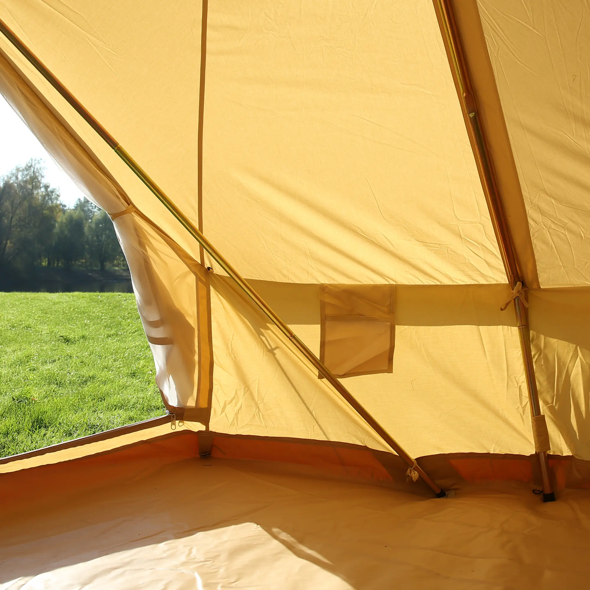 Interior view of your GEAR Gobi 3 cotton tent with UV50+ protection, showing the innovative A-frame poles, no center pole, mesh window, and spacious floor with bathtub groundsheet, set up on grass.