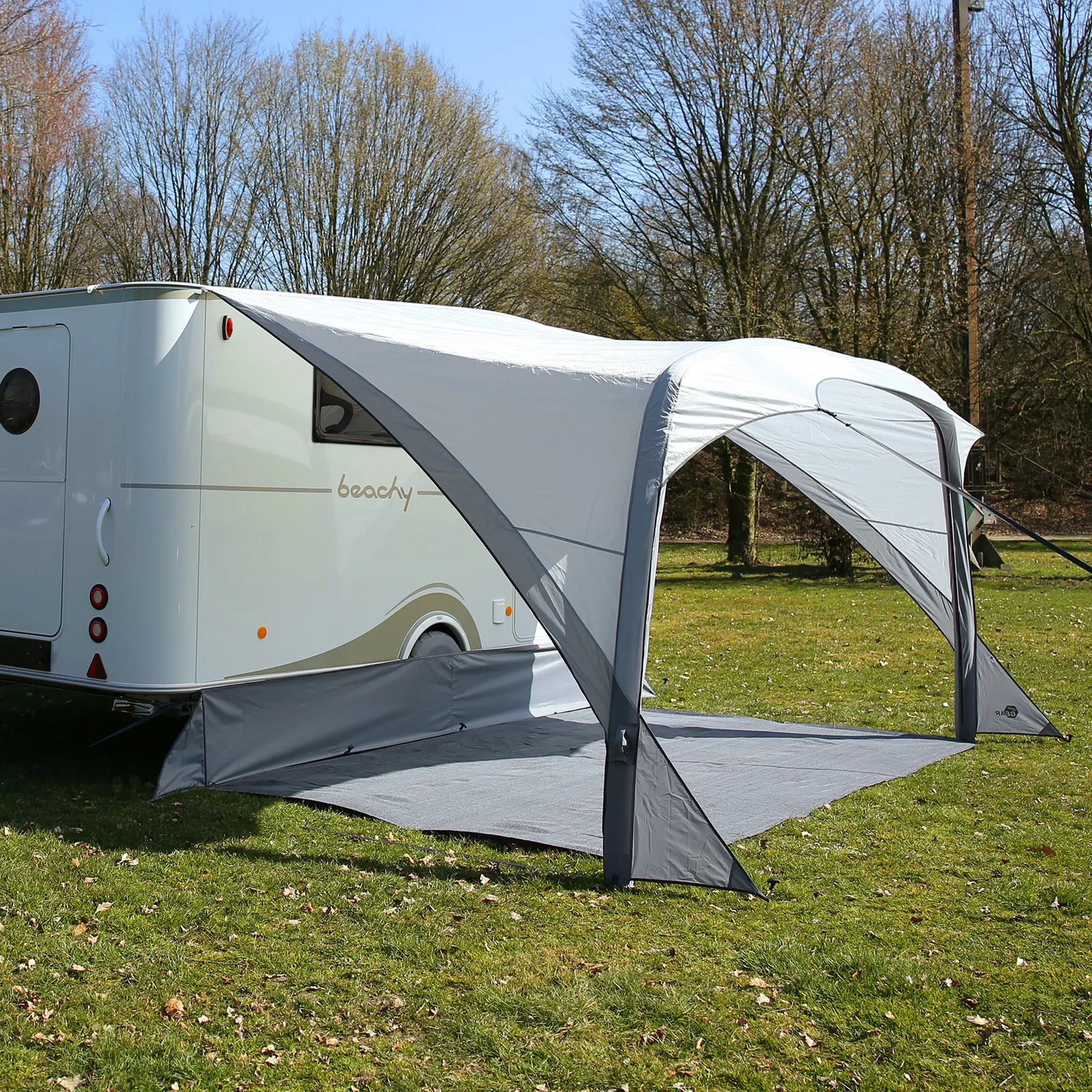 Inflatable your GEAR Amalfi Air 360 caravan sun canopy, tailored fit for Hobby Beachy, shown attached to a white caravan. The canopy is grey, weather-resistant, with large open sides and a groundsheet.