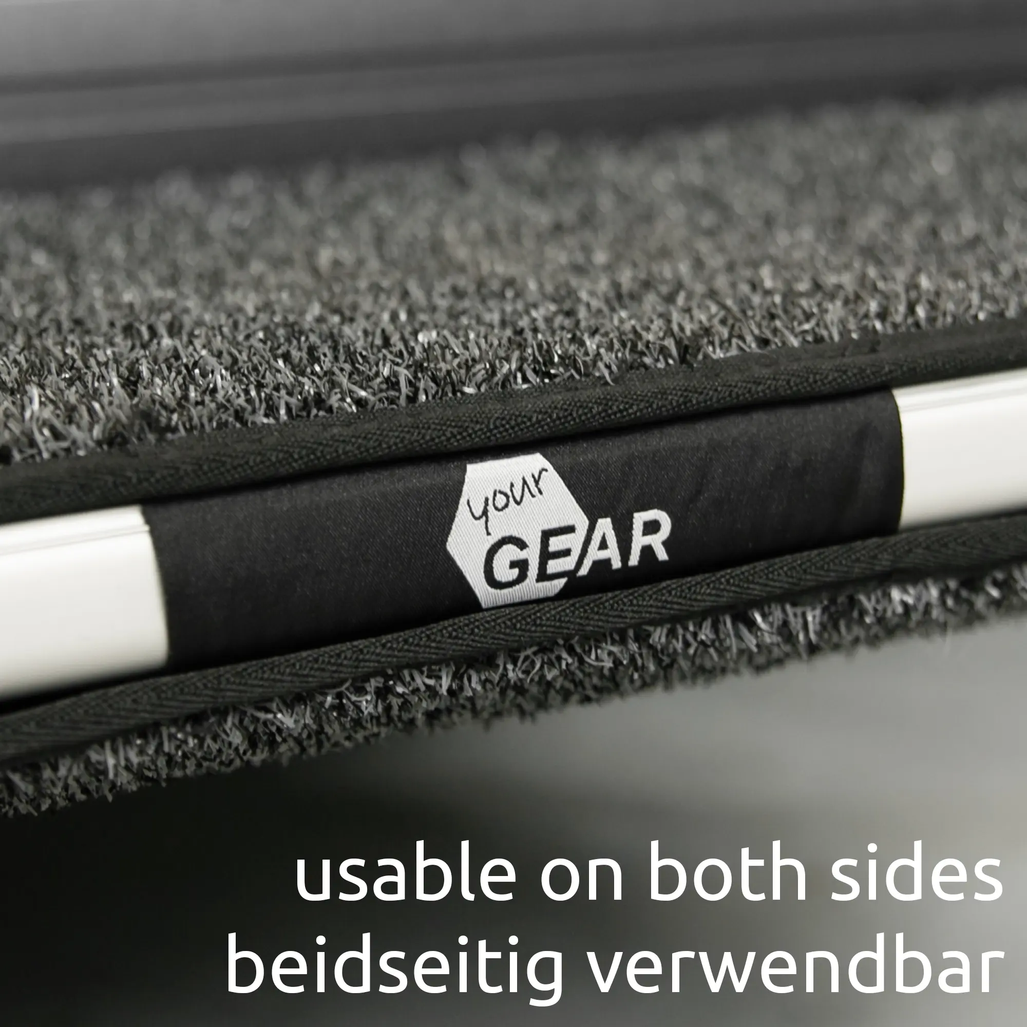 Close-up of your GEAR Mantua 55 x 28 cm RV step mat with grey textured surface, black edge, and your GEAR logo, showing dual-sided usability for motorhome or caravan steps.