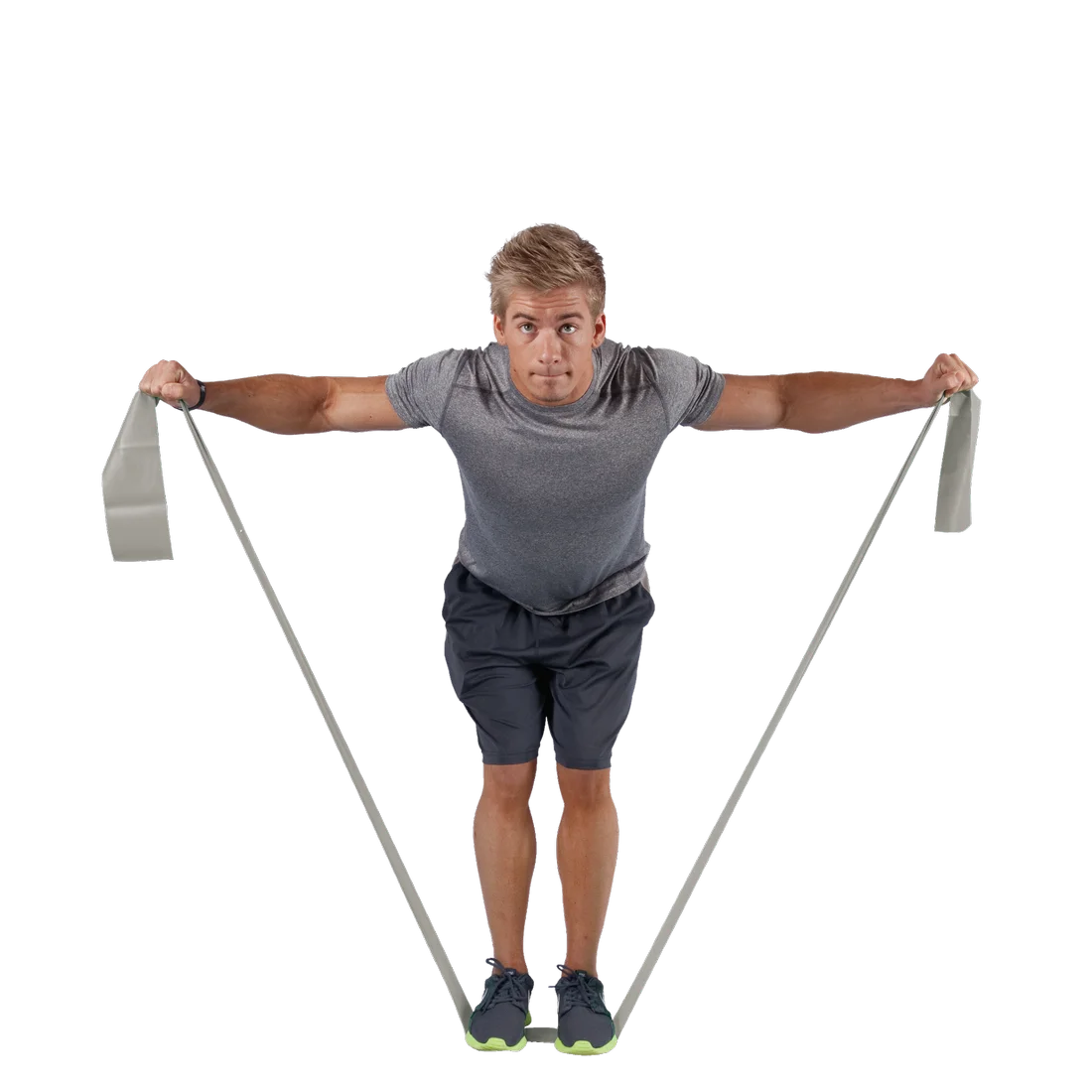 Man exercising with Spirit Fitnessband, latex-free resistance band (183x10 cm, 22.5 kg strength), performing shoulder workout. The grey gym band is stretched between his hands and under his feet.