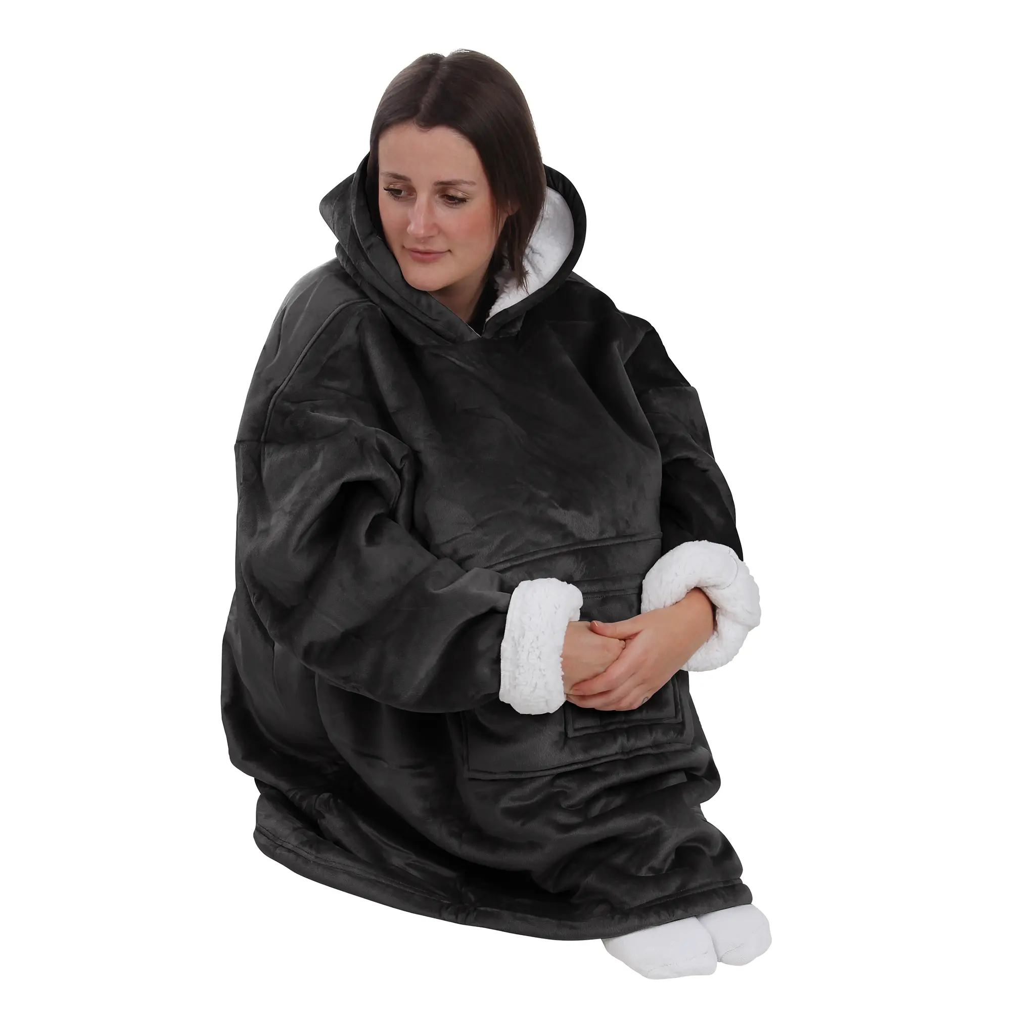 Woman wearing yourGEAR Davos black Sherpa hoodie blanket in oversized unisex XXXL format, featuring soft velour exterior, fluffy white sherpa lining, large hood, two front pockets, and long sleeves.