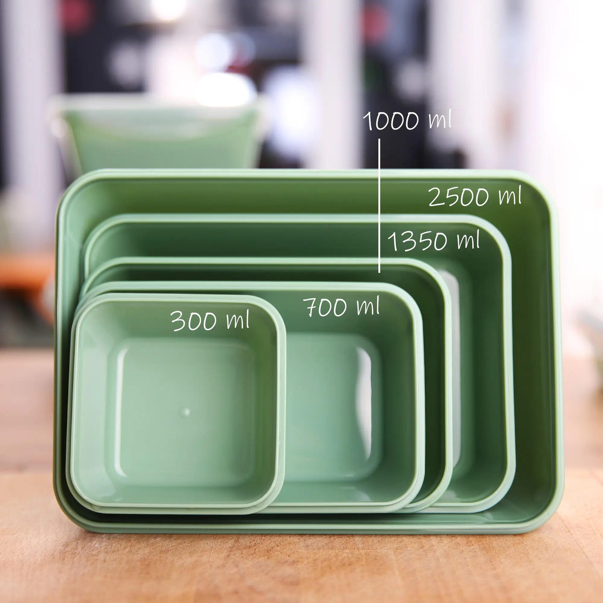 Set of six green your GEAR Pila food storage containers with lids, 300 ml each, stackable, BPA-free, shown nested inside each other, temperature resistant from -20°C to +110°C, ideal for kitchen organization.