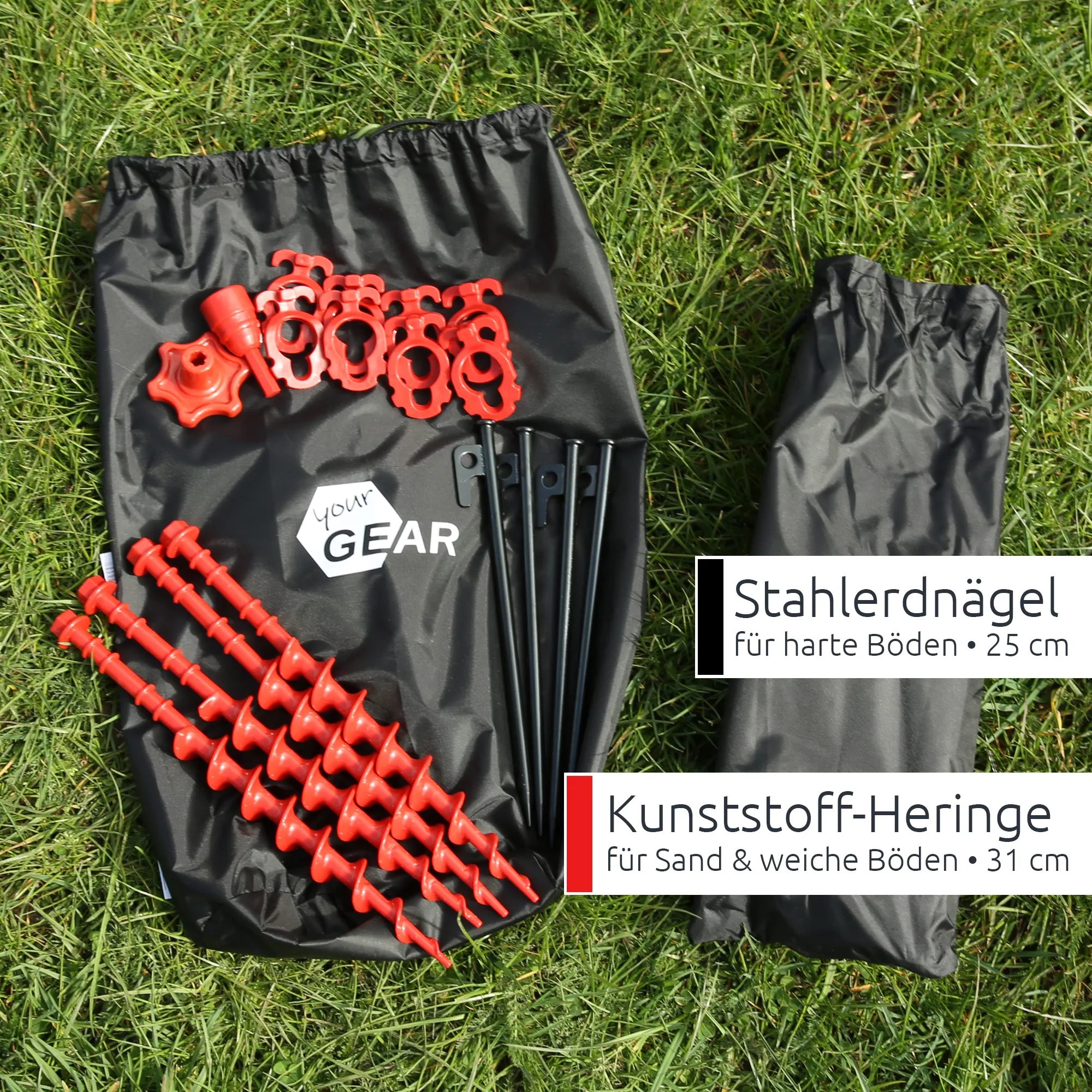 Black your GEAR drawstring bag on grass with red spiral plastic pegs, red plastic clip rings and stake heads, black 25cm steel tent pegs, and a bundled black cover bag — camping awning front wall accessory kit.