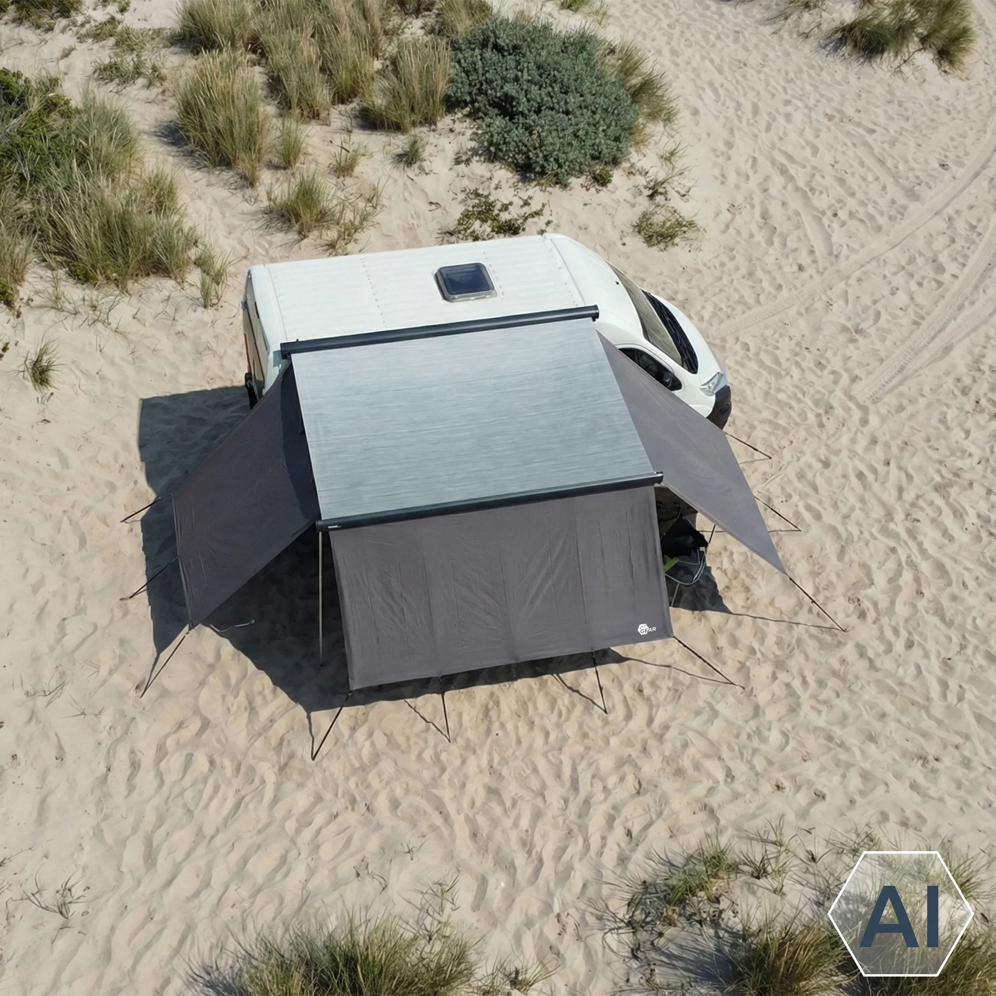 Grey your GEAR Korsika 2.4 awning wall set attached to camper van: central front panel (240x200 cm) with two angled side walls, lightweight grey fabric, tensioned with poles and guy lines, creating weatherproof sheltered extension on sandy beach.