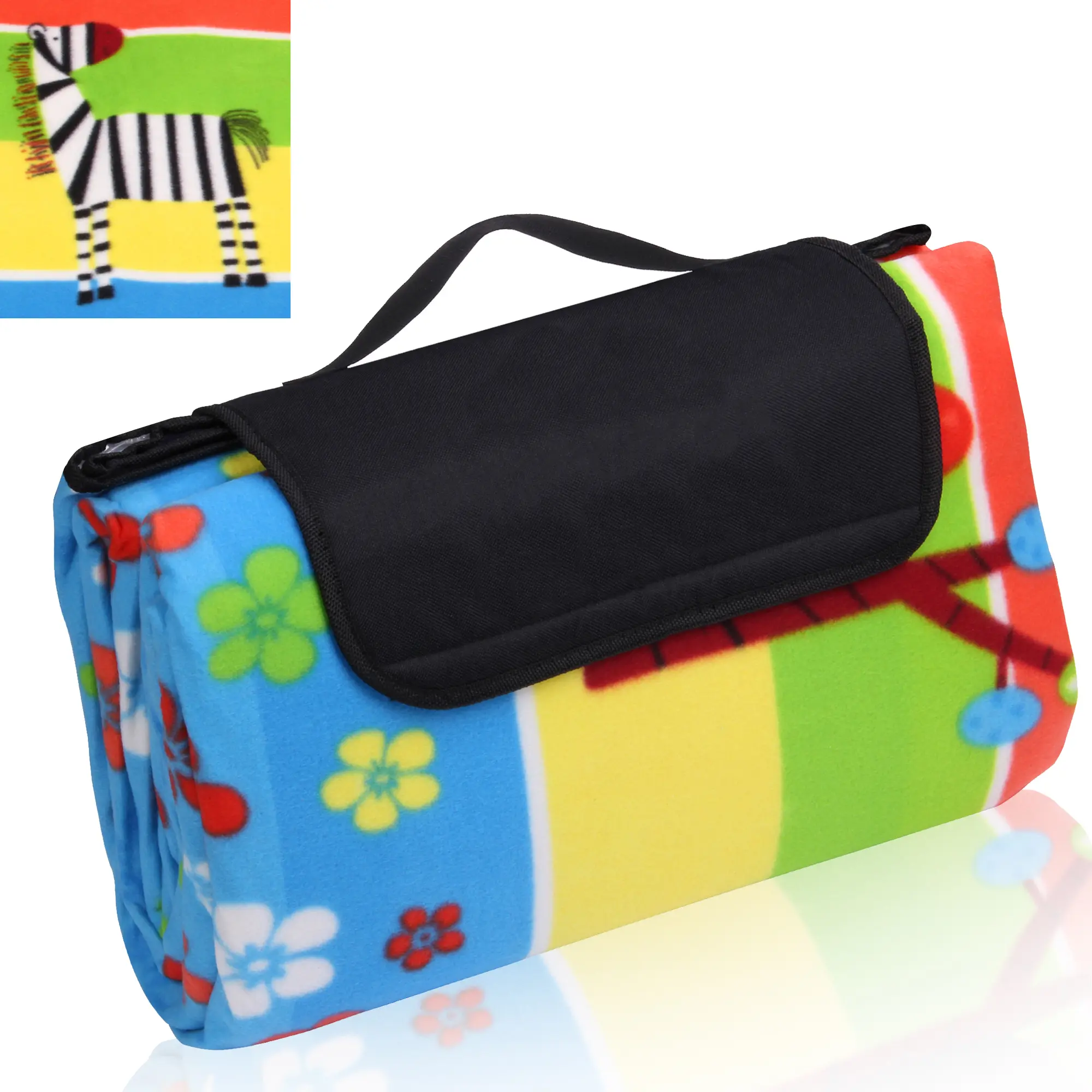 Manta de picnic yourGEAR Kids XL 200x200 cm, plegada con asa negra, diseño colorido de rayas y flores, detalle de cebra, superficie de forro polar, ideal para camping, impermeable y aislante.