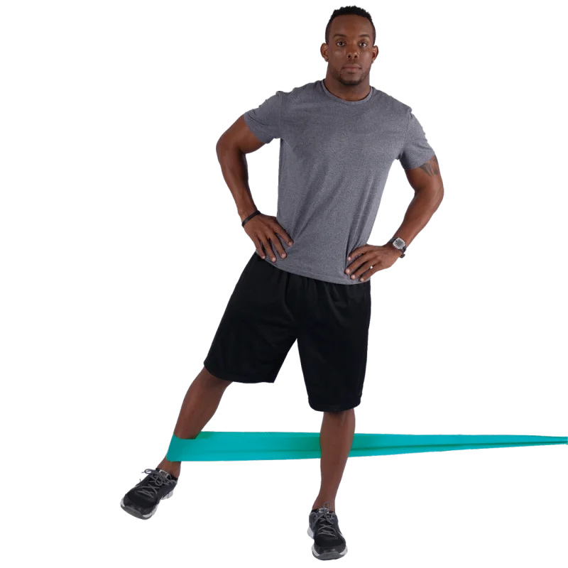 Man using Spirit Fitnessband 13.5 kg latex-free resistance band (183x10 cm) for leg exercise; turquoise band stretched around ankles, suitable for strength and rehabilitation training.