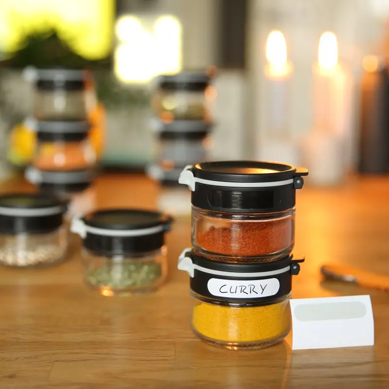 Set de 10 pots à épices your GEAR Double-Flip de 85 ml en verre, avec couvercles noirs rabattables, étiquettes, design empilable et compact, idéal pour organiser les épices dans la cuisine ou les tiroirs.