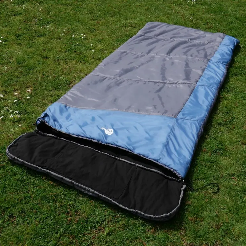XXL sleeping bag yourGEAR Sumatra, blue and grey, rectangular shape, 230x100 cm, with black flannel cotton lining, shown open on grass, suitable for 3-4 seasons camping and outdoor use.