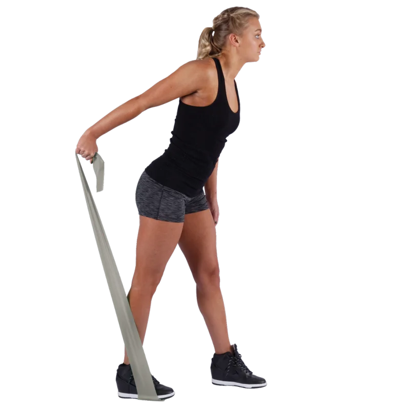 Woman exercising with a Spirit Fitnessband, latex-free resistance band, 183x10 cm, 22.5 kg strength, grey color, used for strength training and rehabilitation. Ideal for full body workouts.