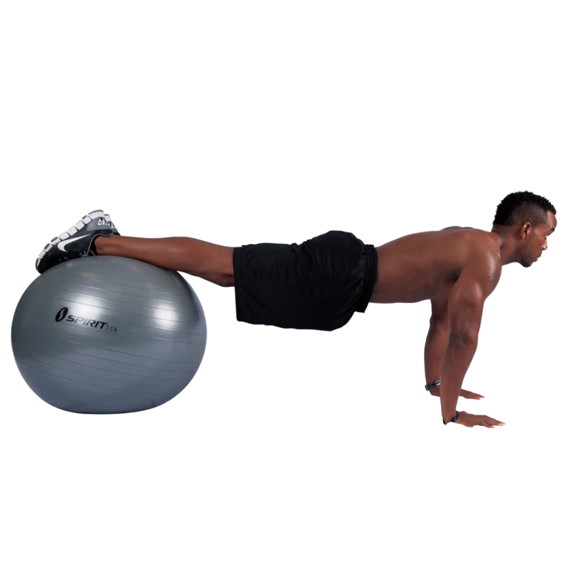 Man exercising with a silver Spirit TCR gym ball, 75 cm diameter, using it for leg support in a plank position; fitness ball suitable for yoga, workouts, and office use.