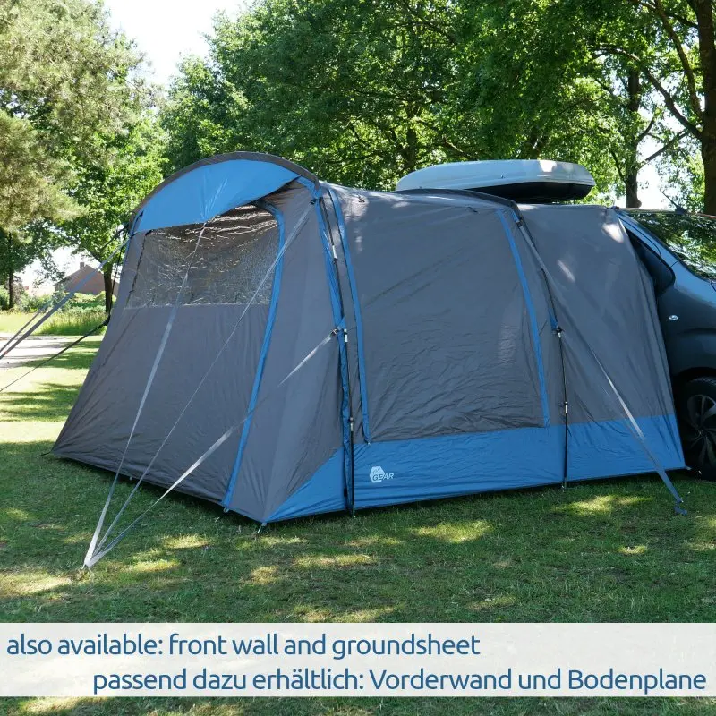 Auvent your GEAR Panarea 320 gris et bleu monté sur un van, grande surface habitable, fenêtres transparentes, tissu imperméable, protection UV 50+, fixé à un véhicule de camping sur gazon.