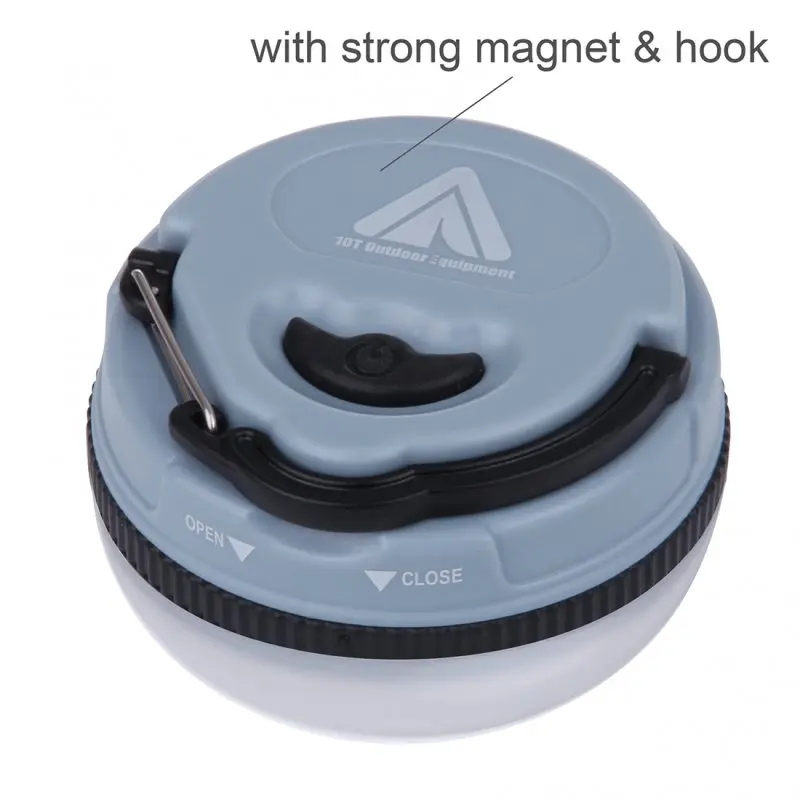 Blue 10T MCL 150 camping lamp with 150 lumens, compact round design, visible power button, strong magnet, metal hook, and open/close markings, suitable for outdoor use.