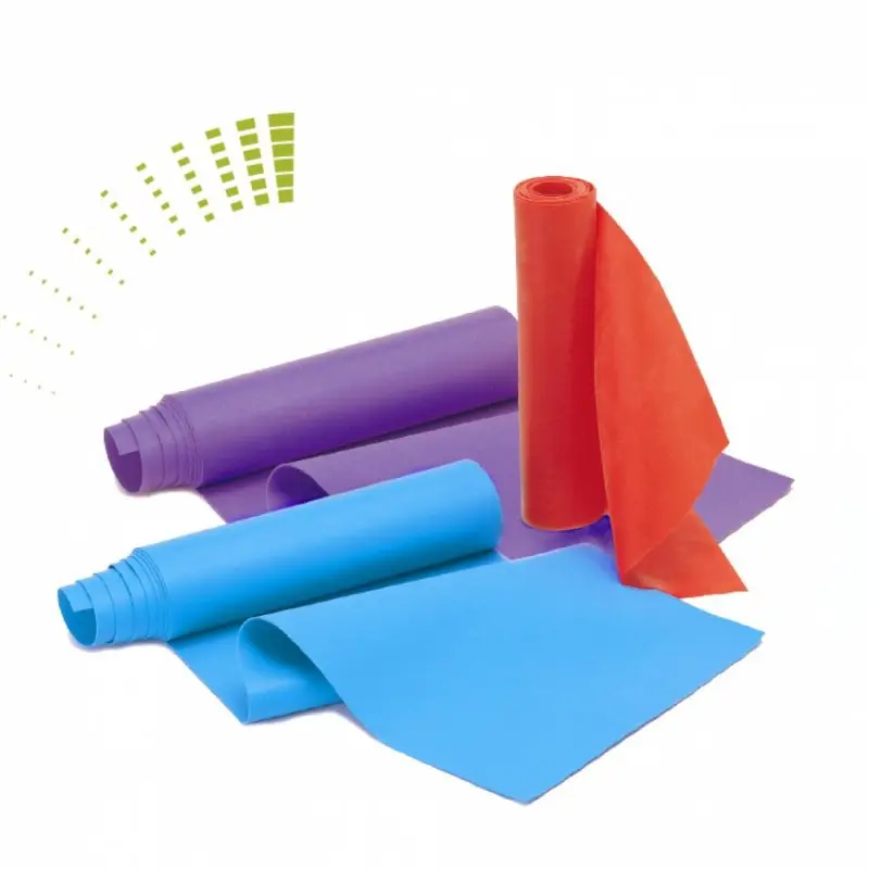 Set of three Carnegie resistance bands in purple, blue, and red, each rolled out flat. Fitness bands made of latex, 120x15 cm, for strength and rehabilitation training, showing three resistance levels.