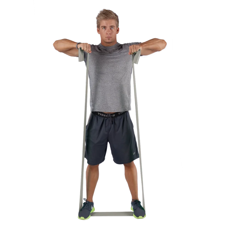 Man exercising with Spirit Fitnessband, 183x10 cm, 22.5 kg resistance, latex-free expander. The grey resistance band is stretched from feet to hands, suitable for strength and rehabilitation training.