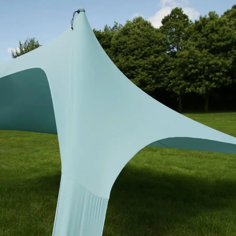 your GEAR Cameo XXL beach shelter 3x3 m in light blue, made from elastic Lycra, set up on grass; provides UV 50+ sun protection, lightweight and ideal for beach, park or outdoor use.