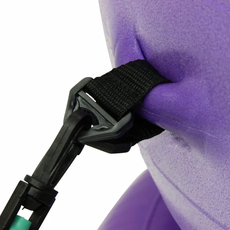 Close-up of a purple Carnegie Iso gymnastics ball with a black resistance band securely attached, showing the textured surface and sturdy plastic clip for versatile strength and balance exercises.
