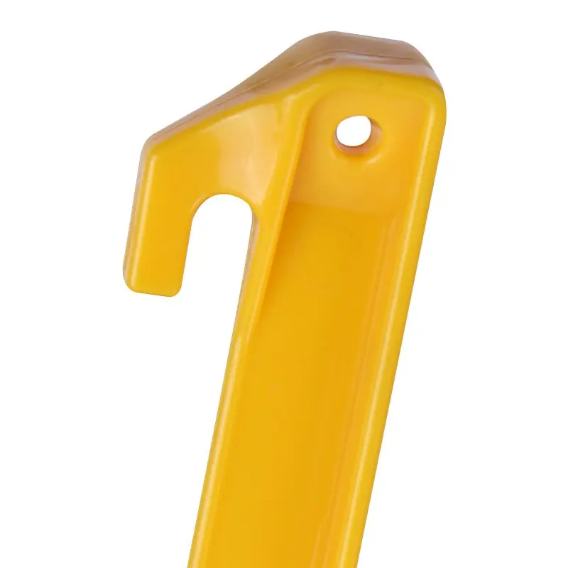 Close-up of a yellow 10T PEG IT TH-30ABS camping tent peg made from durable ABS plastic with T-profile, hook end, and hole for securing tents, tarps, or shelters. Length: 300mm, width: 20mm.