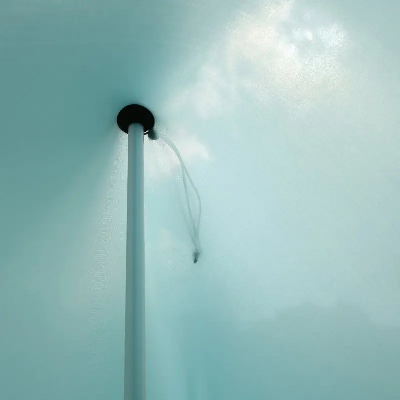 Close-up view of the your GEAR Cameo Beach Shelter’s elastic Lycra fabric in light blue, showing the central pole and reinforced attachment point for stability and UV 50+ sun protection.