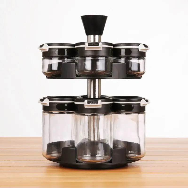 your GEAR Double-Flip spice rack with 12 glass jars (6 x 200 ml, 6 x 85 ml), black lids, carousel design, stainless steel center, displayed on a wooden surface for organized kitchen storage.