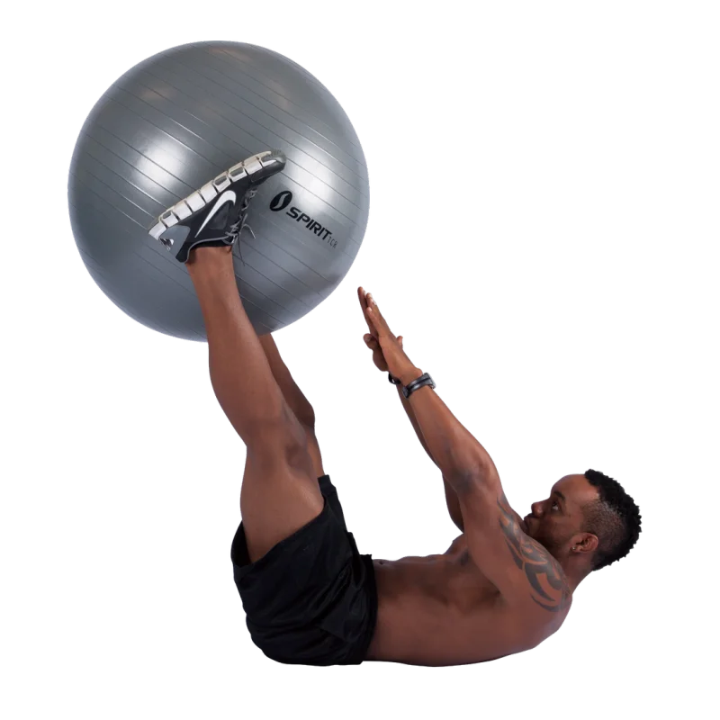 Man exercising with a silver Spirit TCR gym ball, 75 cm diameter, using it for abdominal workout. The fitness ball features a durable, anti-burst surface and is ideal for yoga, fitness, and office seating.