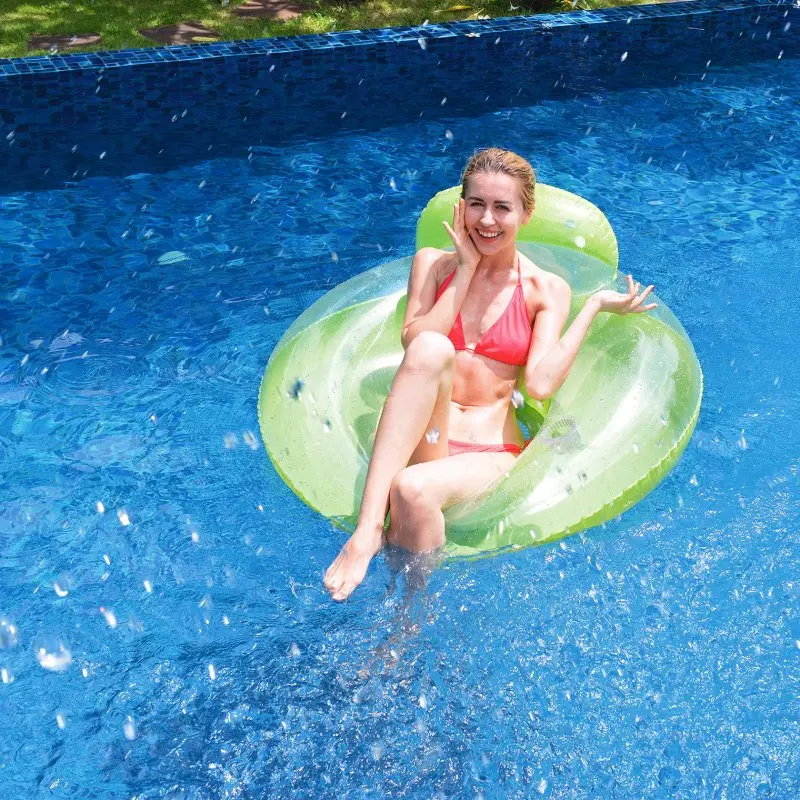 Woman relaxing on a green Jilong Pool Lounge inflatable chair with high backrest and drink holder, floating in a swimming pool. Pool chair measures 118 cm in diameter, suitable for adults and children.