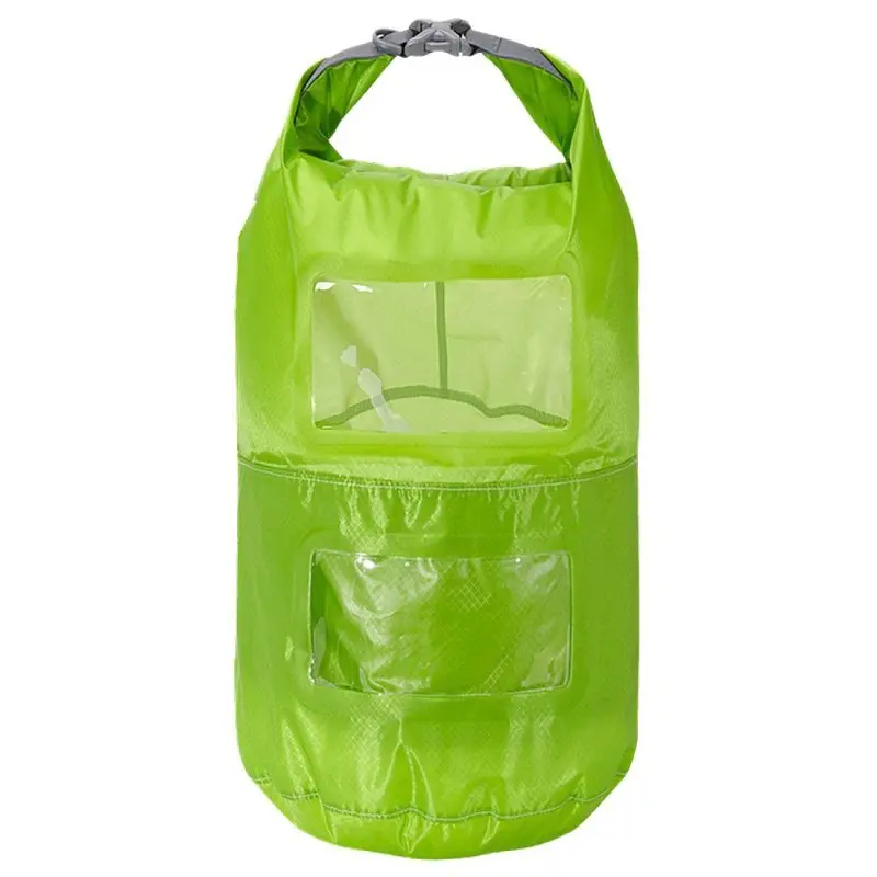 Lightweight green Trekmates 15L dry bag with two compartments, transparent viewing windows, roll-top closure with buckle, and waterproof nylon material. Ideal for organized, visible storage during outdoor activities.
