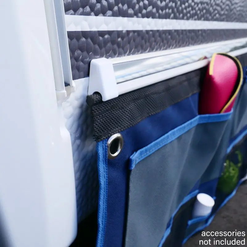 your GEAR Caravan Organizer Wide hanging shelf with 6 blue mesh pockets, attached to a caravan wall via a rail and grommets, ideal for tents and camper storage; accessories not included.