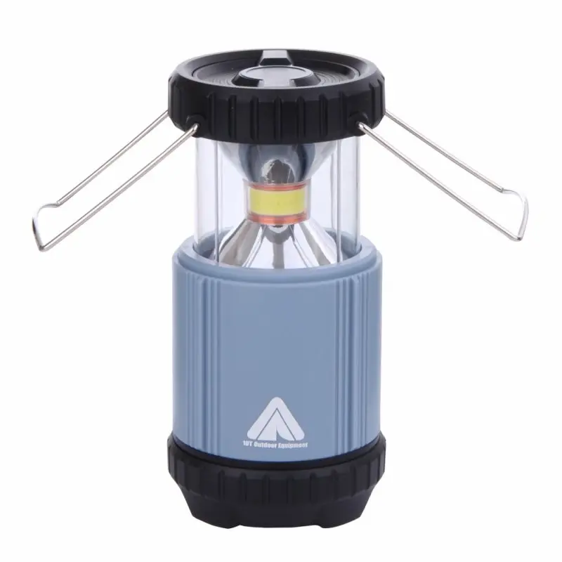 Blue 10T COL 300 camping lantern with 300 lumens, COB LED 5W, cylindrical shape, transparent upper section, black top and base, metal carrying handles, and 10T Outdoor Equipment logo on the side.