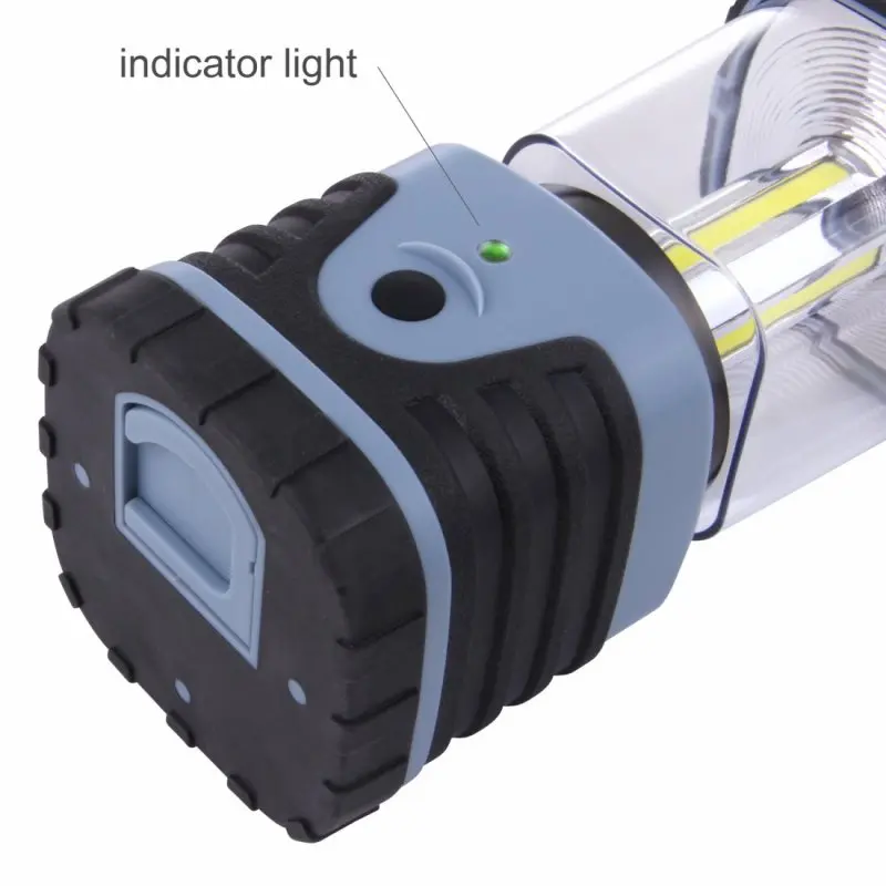 Close-up of the 10T HPL 500 camping lantern in blue with textured black grip, indicator light, and visible COB LED strips inside the transparent housing. Rugged design for outdoor use.