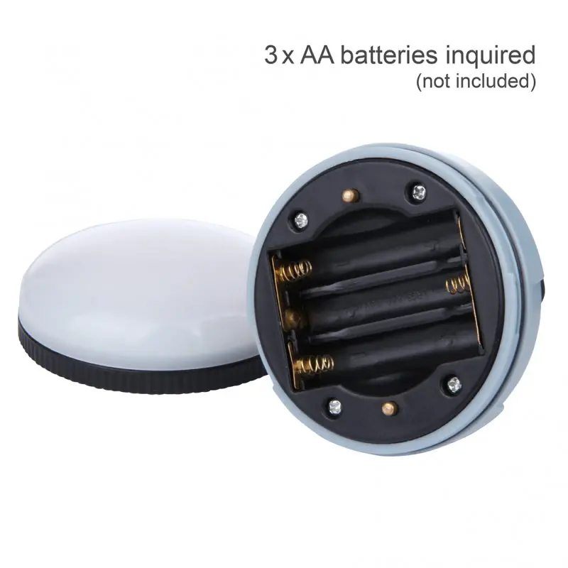 Blue 10T MCL 150 camping lamp with open battery compartment for 3 AA batteries, round ABS plastic body, white diffuser, compact design, suitable for outdoor use, batteries not included.