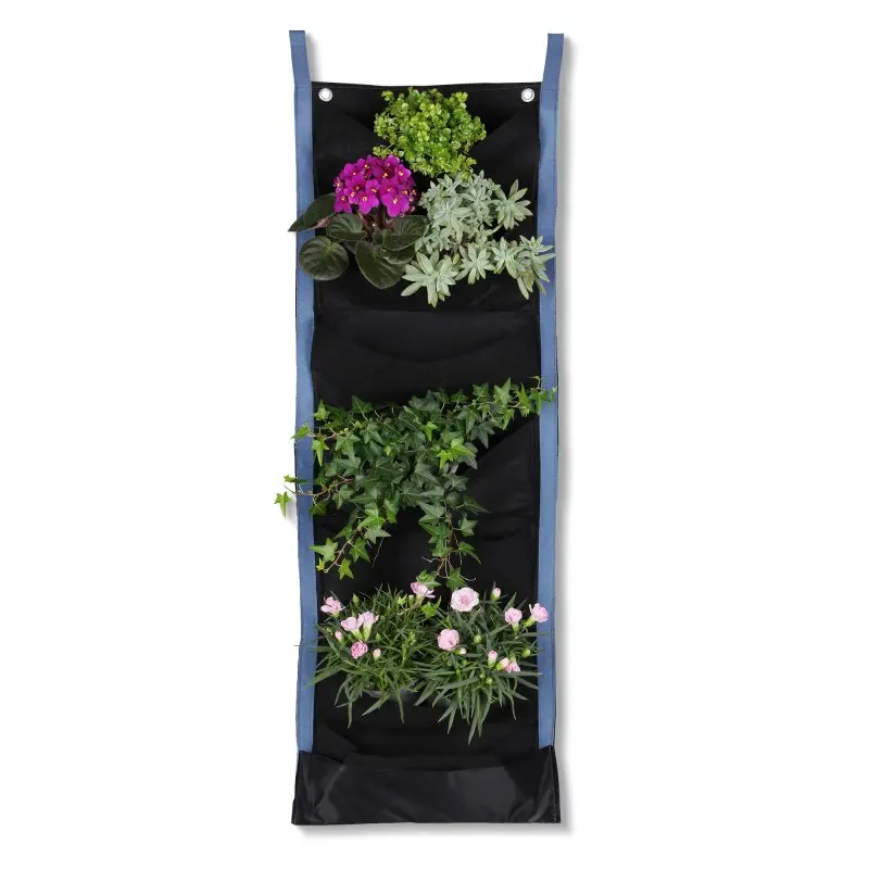 Sac de culture mural yourGEAR Growbag avec 7 poches en tissu non tissé noir, bord bleu, fixé par œillets métalliques, contenant différentes plantes et fleurs, idéal pour jardin vertical ou mur végétal.