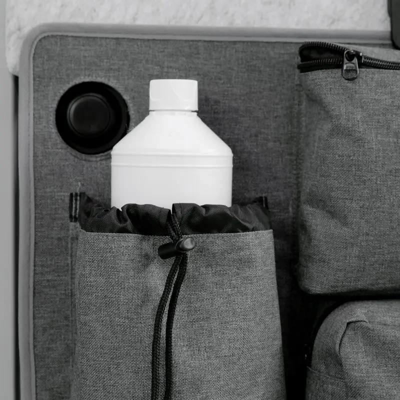 your GEAR Ortles R organizer for camper van rear door, shown in grey fabric with multiple pockets, including a drawstring pocket holding a white bottle, and zippered compartments for versatile storage.