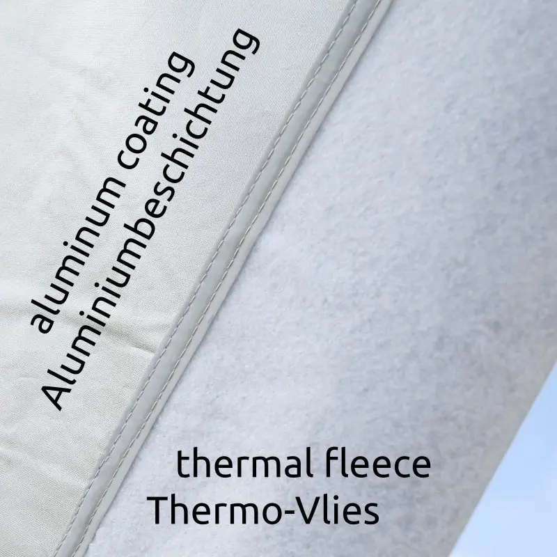 Primer plano de la Bugschutzplane your GEAR para caravana, mostrando la capa exterior con recubrimiento de aluminio y el interior de forro térmico. Protección térmica para frente y trasera de caravanas, 165 x 160 cm.
